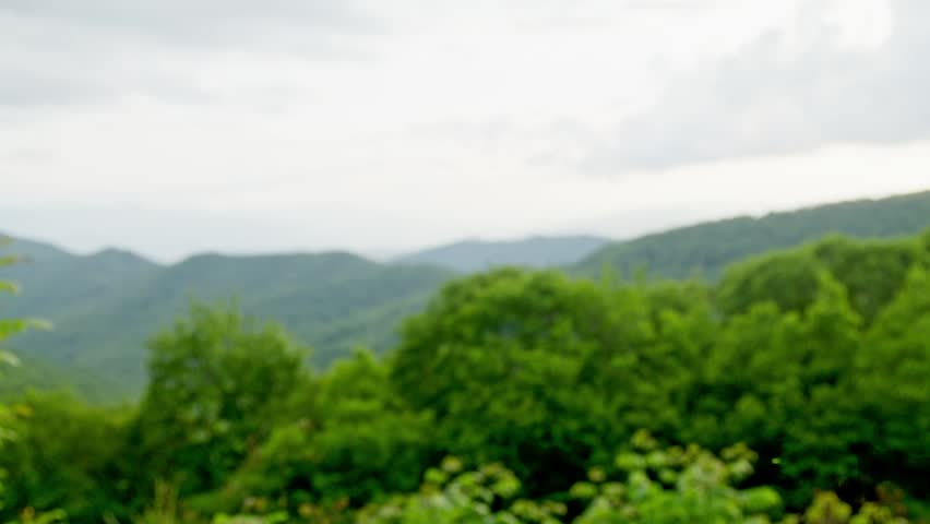 Great Smoky Mountains National Park green mountains in summer with rack focus.