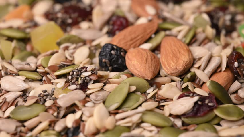 Rotating Healthy Trail Mix Macro Angled Top View with Seeds Nuts and Dried Fruits