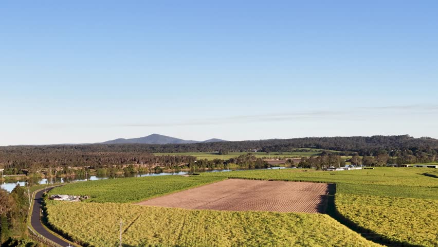 High angle drone shot of agricultural fields and river in Maclean, New South Wales, Australia.