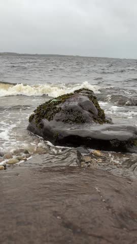 Waves hitting a rock on the shore