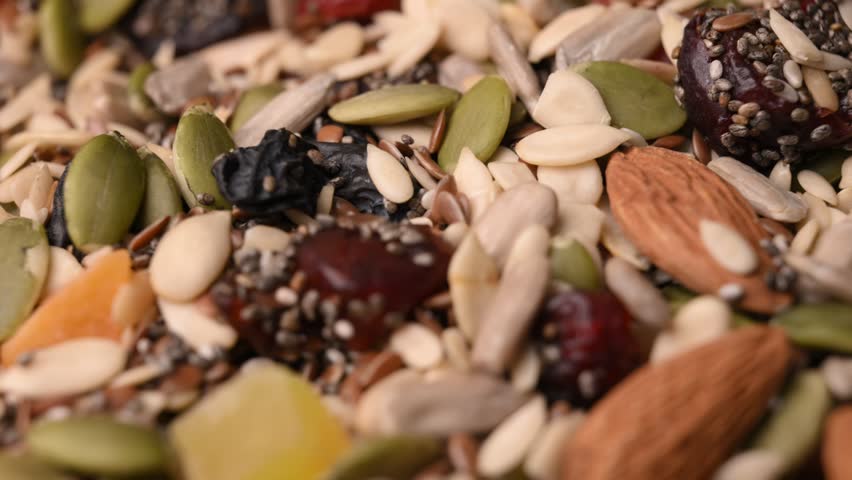 Rotating Healthy Trail Mix Macro Angled Top View with Seeds Nuts and Dried Fruits