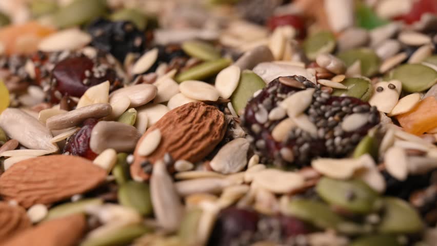 Rotating Healthy Trail Mix Macro Angled Top View with Seeds Nuts and Dried Fruits