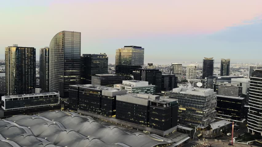 Elevated urban panorama of the modern Melbourne city skyline featuring corporate skyscrapers and architecture of the business district at sunrise