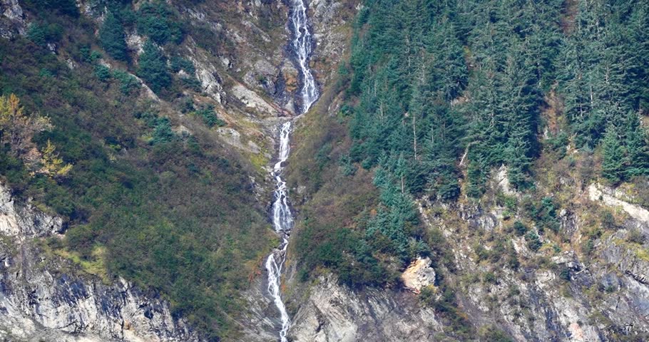 Waterfall cascading down mountain in Juneau, Alaska