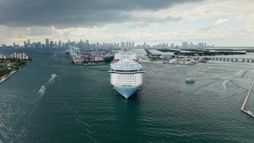 Aerial view of cruise ship in vacation summer. Cruise ship vacation and travel at sea. Aerial drone view of luxury liner. Ship leaving Miami beach port. Sea tour. Cruise ship vacation
