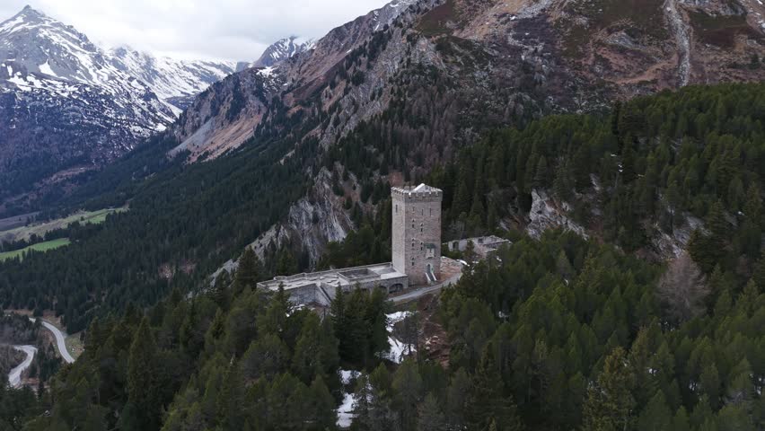 Drone view of the Belvedere Tower on the Maloja Pass surrounded by a pine forest in Switzerland