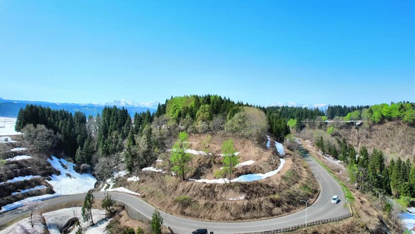 Drone Aerial Footage of Shinano River Viewpoint Parking Area in Tokamachi, Niigata, Japan

Drone aerial footage of the Shinano River Viewpoint Parking Area in Tokamachi, Niigata, Japan, featuring panoramic views of the Shinano River, rural countryside, terraced fields with remaining snow, surrounding mountains, and a scenic overlook. Captured in spring, this cinematic aerial video highlights the natural beauty and peaceful landscape of Japan from above.