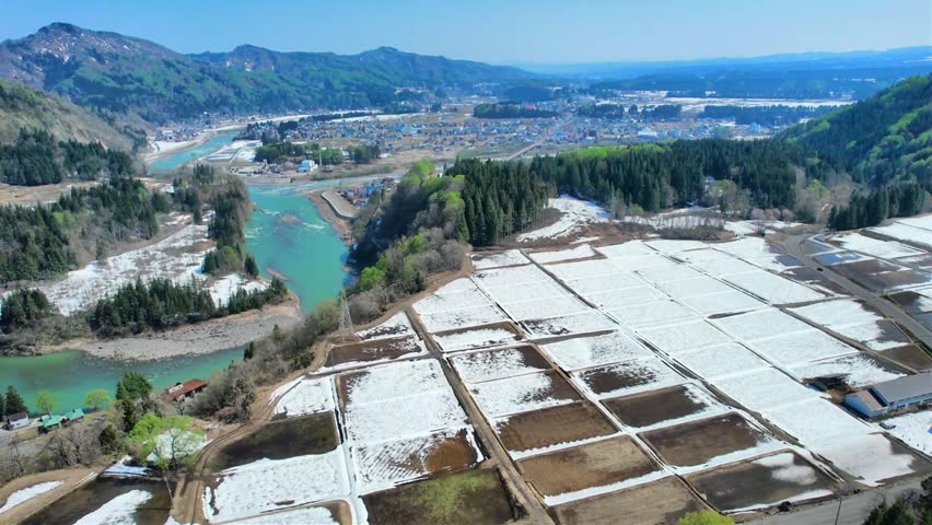 Drone Aerial Footage of Shinano River Viewpoint Parking Area in Tokamachi, Niigata, Japan

Drone aerial footage of the Shinano River Viewpoint Parking Area in Tokamachi, Niigata, Japan, featuring panoramic views of the Shinano River, rural countryside, terraced fields with remaining snow, surrounding mountains, and a scenic overlook. Captured in spring, this cinematic aerial video highlights the natural beauty and peaceful landscape of Japan from above.