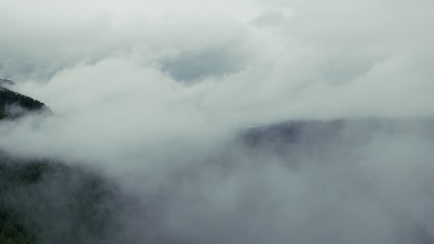 Low clouds drift over Sproat Lake and forested shoreline near Port Alberni