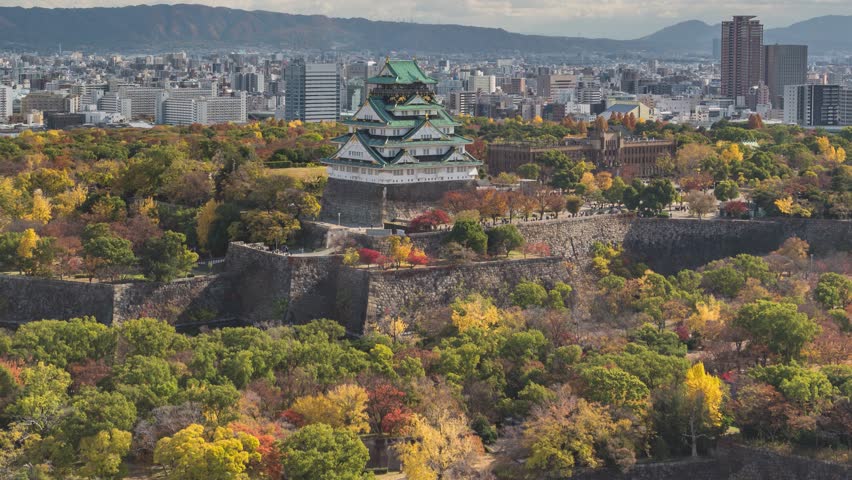 Osaka Japan time lapse city skyline at Osaka Castle in autumn season