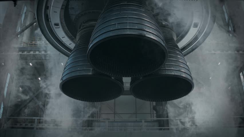 Powerful rocket engines ignited at the launch pad, filling the aerospace facility with glowing exhaust, steam, and smoke in preparation for a space mission.