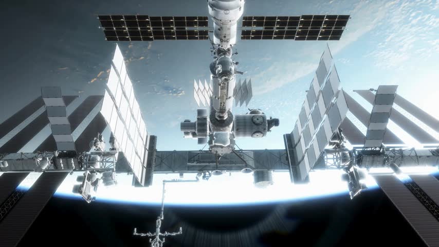 Orbital view of International Space Station floating above Earth with bright sun reflection hitting massive solar panels background communication space technology science internet satellite orbit