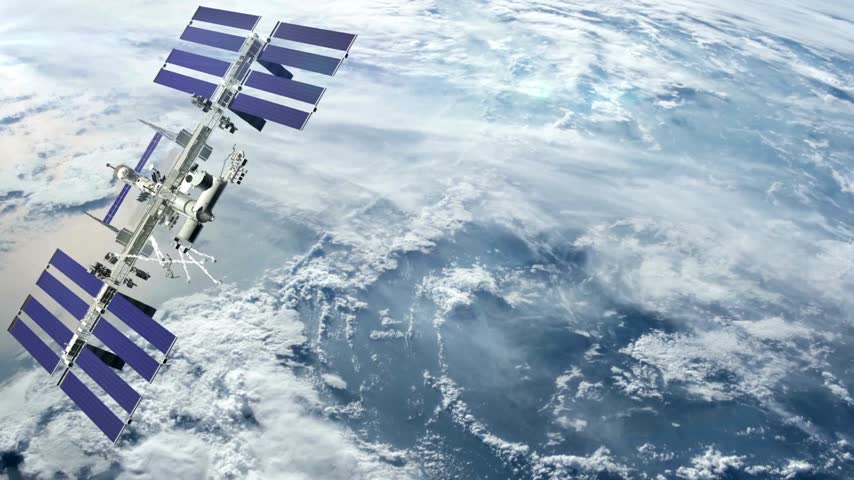 International Space Station flies over Earth showcasing detailed solar panels against a backdrop of swirling clouds and colors during sunset. Unique perspective from space