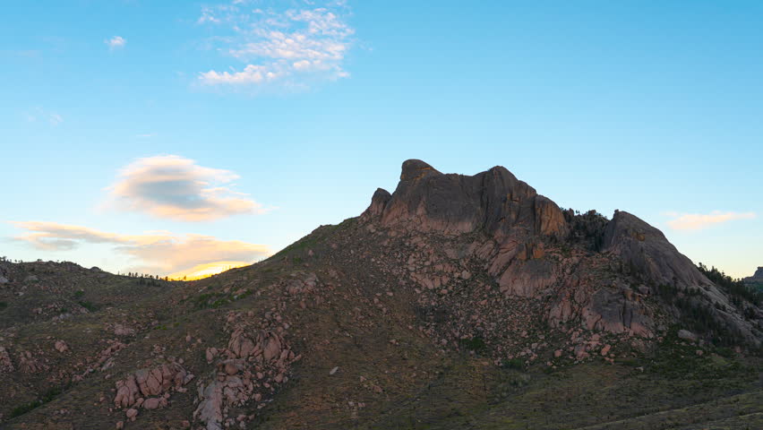 Static shot of a rugged rocky mountain peak in Pike San Isabel National Forest as evening light fades.