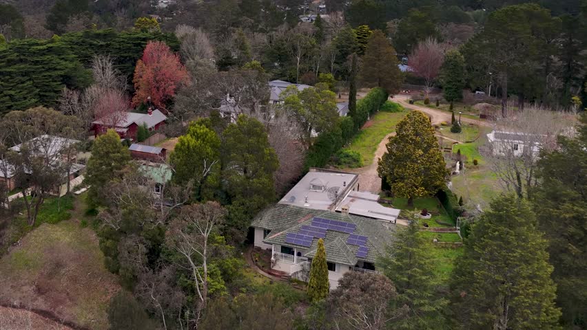 Drone shot of residential homes nestled among lush greenery and eucalyptus trees in Wentworth Falls.