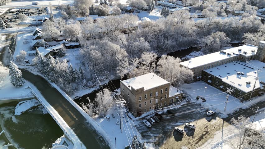 Tilted River Bridge Grafton Wisconsin Aerial after Winter Snowstorm, small town and river snow covered