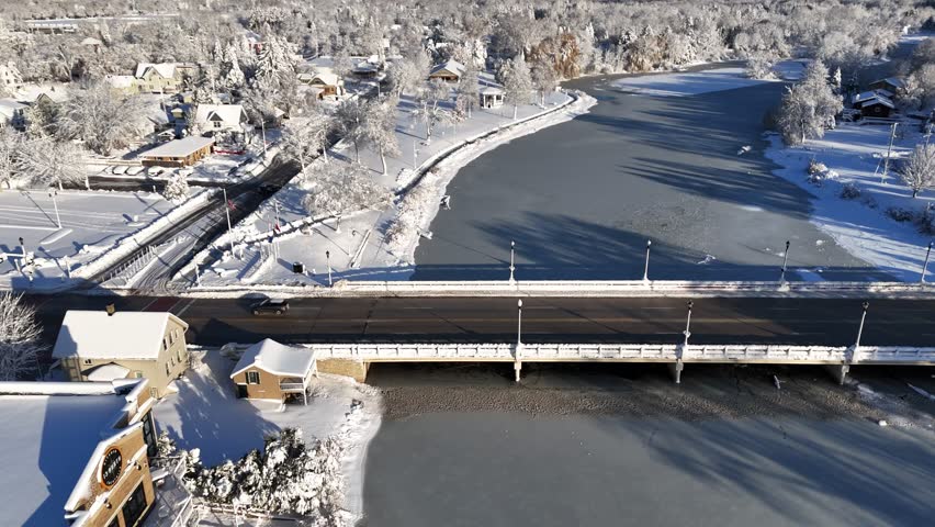 Over Bridge Grafton Wisconsin Aerial after Winter Snowstorm, small town and river snow covered