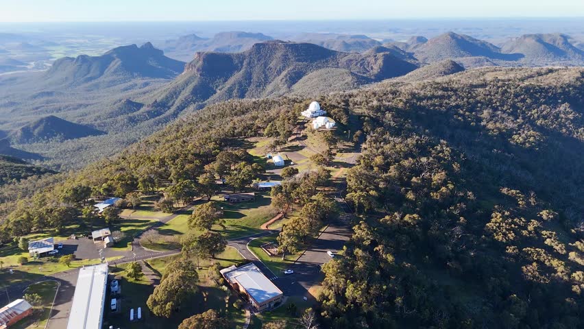 Drone shot of observatory domes on a mountain ridge in Warrumbungle National Park, Australia.