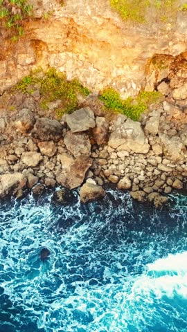 Top down rocky Ngerenean coast with breaking waves
