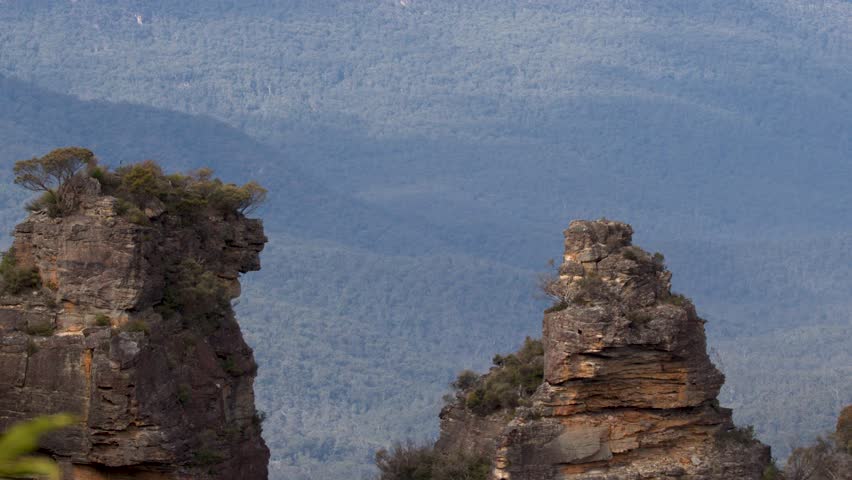 Static telephoto shot of sandstone pillars overlooking Jamison Valley in Blue Mountains, New South Wales.
