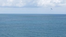 Video of Para-sailing over blue ocean water being pulled by a boat