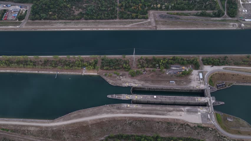 Aerial view of the lock system at the CNPE de Fessenheim, featuring concrete infrastructure and calm canal waters in Fessenheim, Grand Est, France.