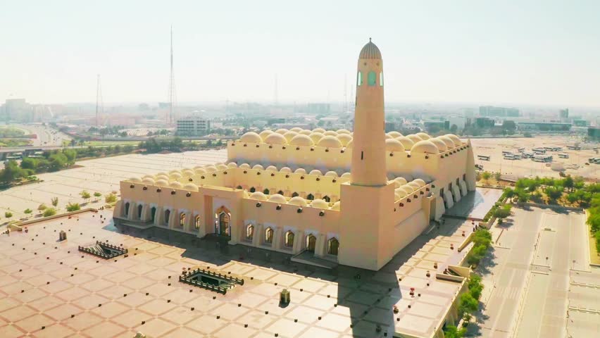 Imam Abdul Wahhab Mosque in Qatar captured in a stunning drone shot, showcasing its grand Islamic architecture and surrounding urban landscape.