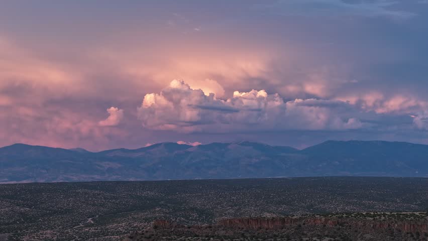 Aerial view of the Sangre de Cristo Range with dramatic sunset clouds over the landscape in Los Alamos, NM, United States.