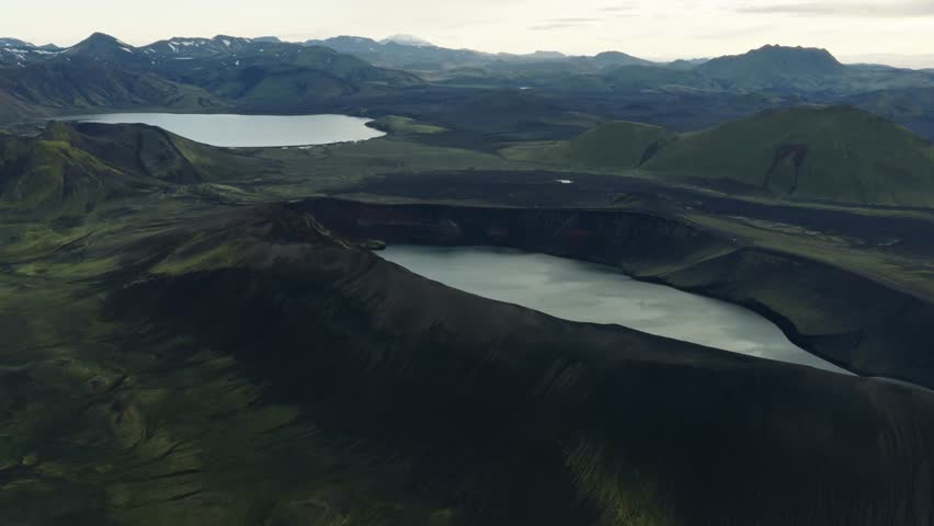 Aerial drone footage of the colorful Landmannalaugar Highlands in Iceland, featuring volcanic mountains, winding rivers, lava fields, and breathtaking untouched wilderness.