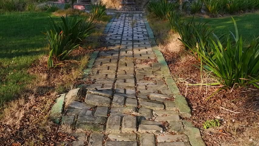 Old Stone Walkway Through a Peaceful Garden in Golden Light