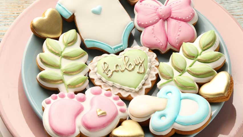 Yummy baby shower cookies on table, rotating