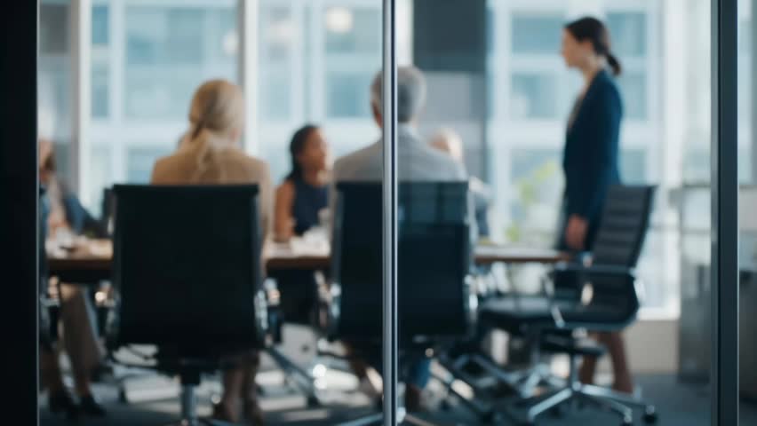 Female Leader Presenting to Business Team in Modern Glass Conference Room