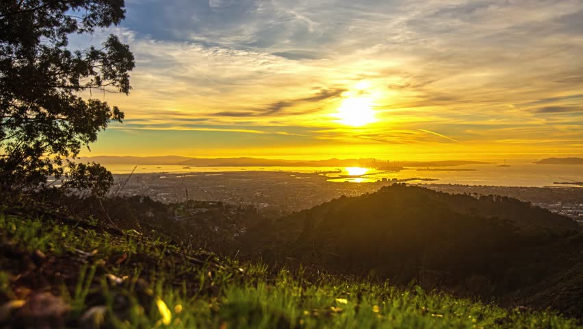 View of the golden hour sunset over the city skyline and bay in San Francisco, California, United States.