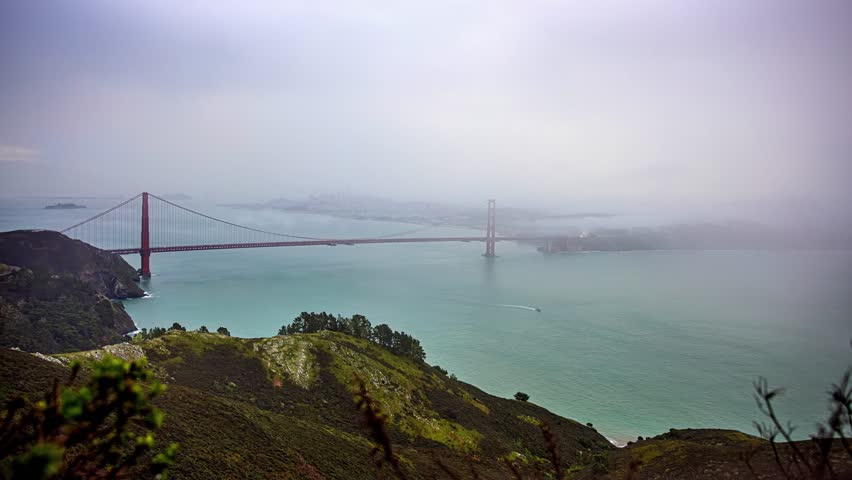 View of the Golden Gate Bridge shrouded in thick fog over the bay in San Francisco, California, United States.