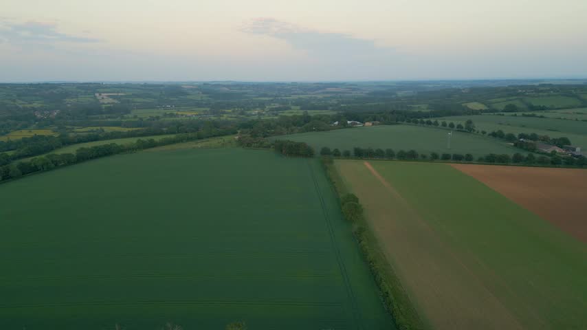 Scenic sunset views of rolling farm fields in the Cotswolds near Bourton-on-the-Water, Gloucestershire, England