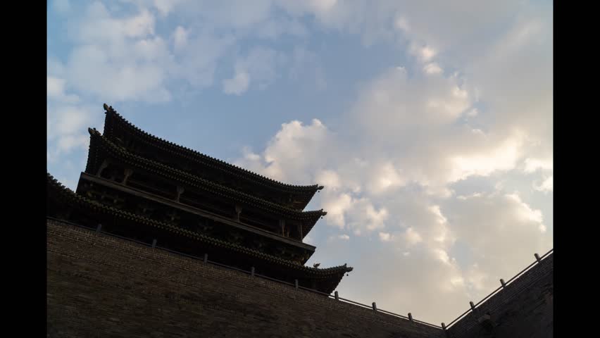 Silhouette of a traditional Chinese ancient pavilion tower against a beautiful cloudy sky