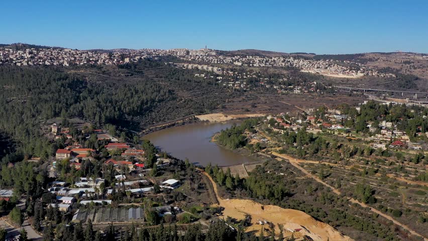 High altitude panorama over the agricultural campus and water retention reservoir in the Jerusalem hills region.