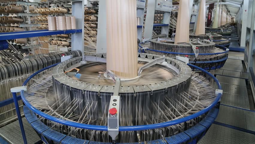 Industrial circular loom machine weaving plastic polypropylene fabric for bags in a factory