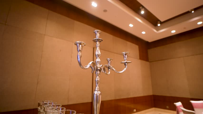 A silver candelabra centerpiece set in a luxury hotel banquet hall in Mumbai, India.