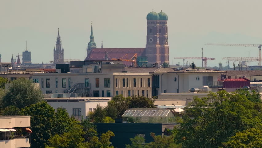 Aerial panoramic view of the Munich skyline featuring the iconic Frauenkirche, St. Peter