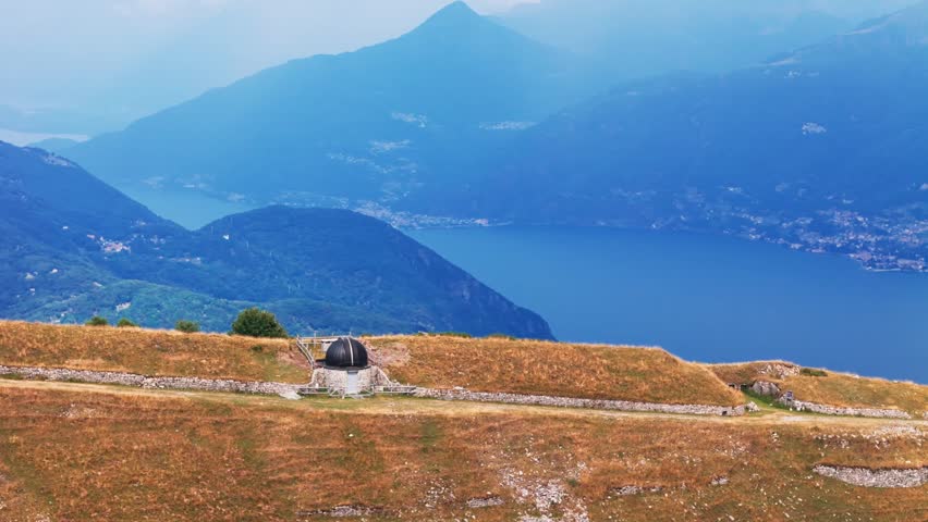 Aerial view of world war one trenches and military fortifications on monte crocione, with a stunning panorama of lake como and the alps