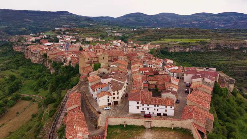 Cantavieja historic templar village perched on rocky cliffs in Teruel, Aragon, Spain, with terracotta rooftops, medieval architecture and green valley landscape