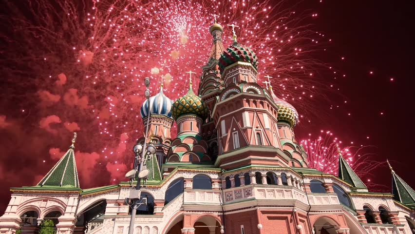 Temple of Basil the Blessed and fireworks in honor of Victory Day celebration (WWII), Red Square, Moscow, Russia. Time lapse, with zoom