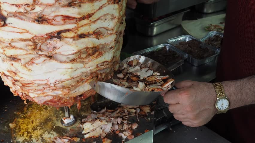 latin man making tacos al pastor.