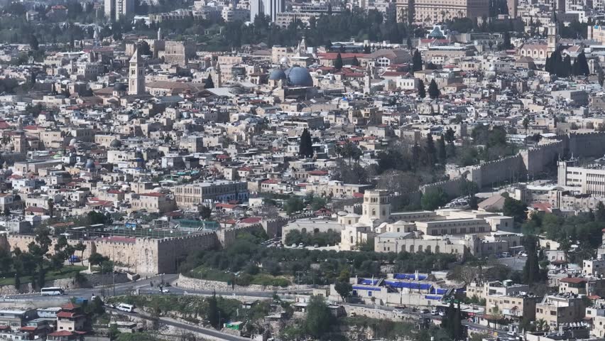 High angle vista of the Rockefeller Archaeological Museum, Christian Quarter church towers, and ancient limestone city walls in Jerusalem.