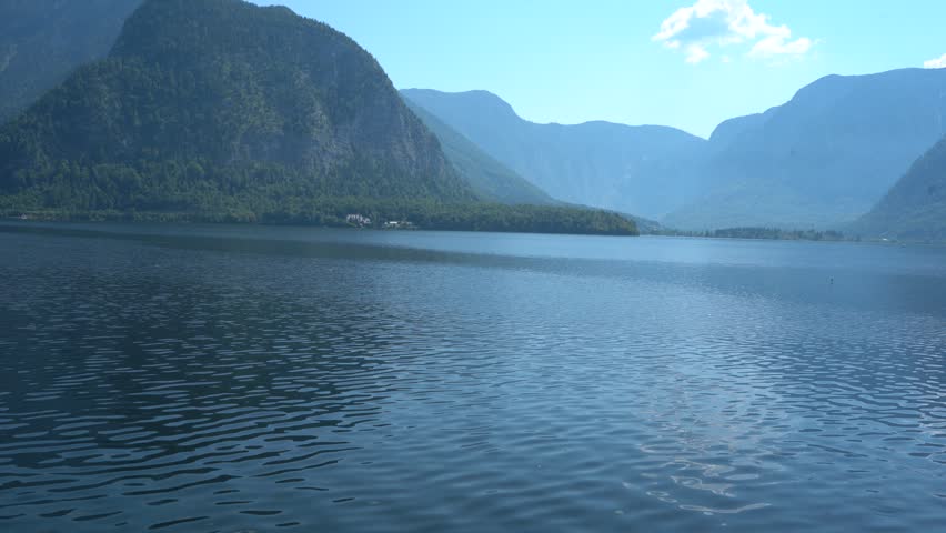 Hallstatt Lake with Alpine Mountains and blue water in Austria Nature.