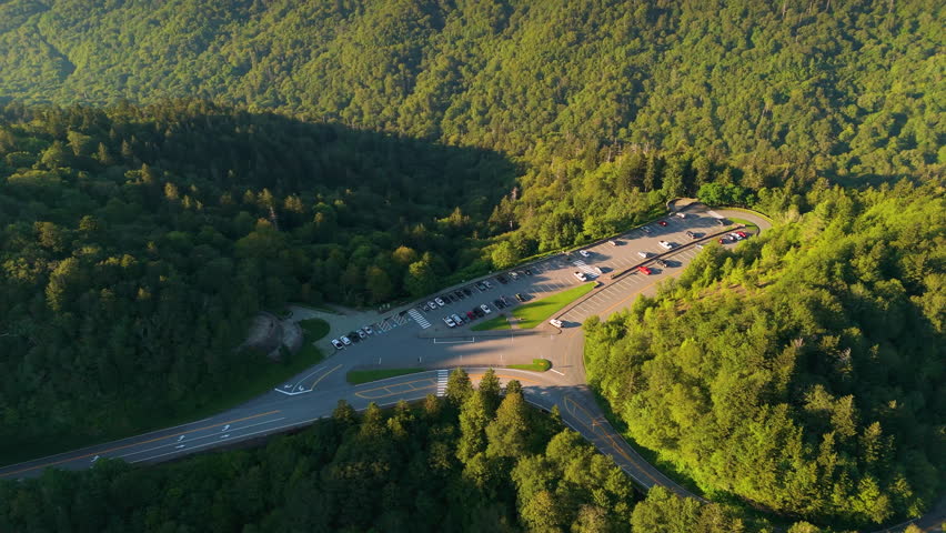 Car parking area for hikers and travelers at Newfound Gap overlook in Appalachian Mountains in summer. Mountain pass along the border of Tennessee and North Carolina.