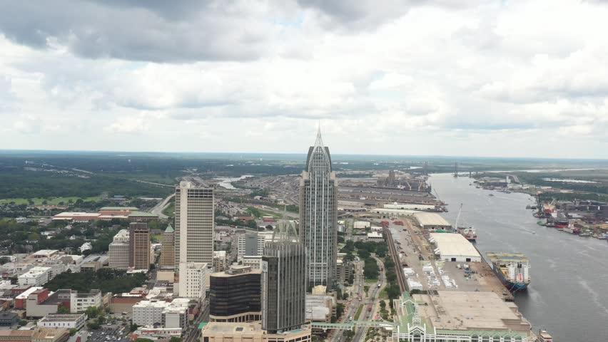 4K afternoon drone footage overlooking the heart of downtown Mobile, Alabama, featuring historic and modern architecture along the Gulf Coast.