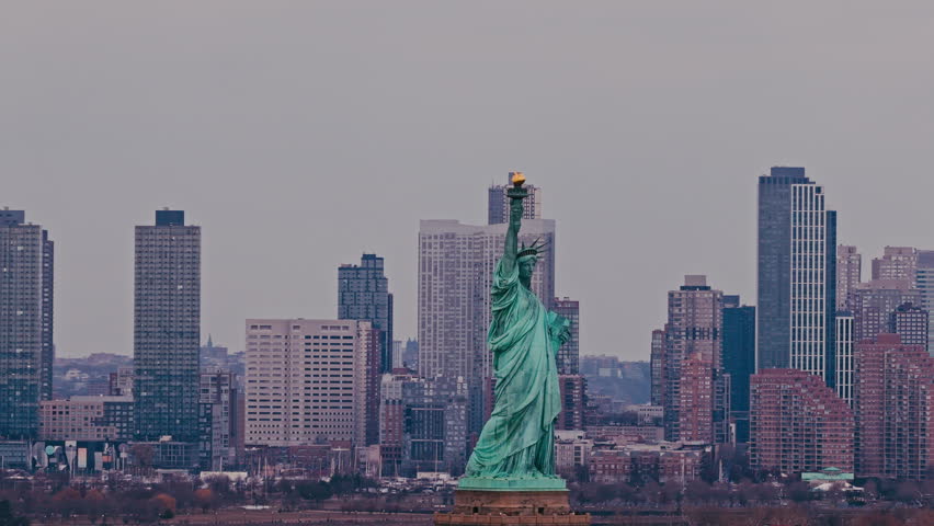 Liberty statue and downtown skyline. Aerial perspective of Liberty statue over New York City. Liberty statue overlooking New York City. Aerial waterfront view with Liberty statue and NYC skyline.
