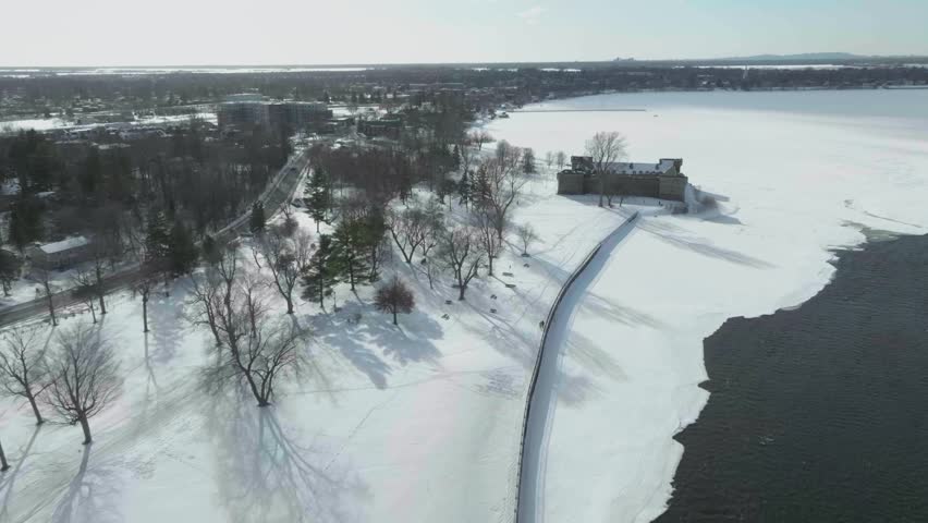 drone flying along the main river richeliau in chambly quebec canada exposing the old town n the castle fort chambly n the coastline